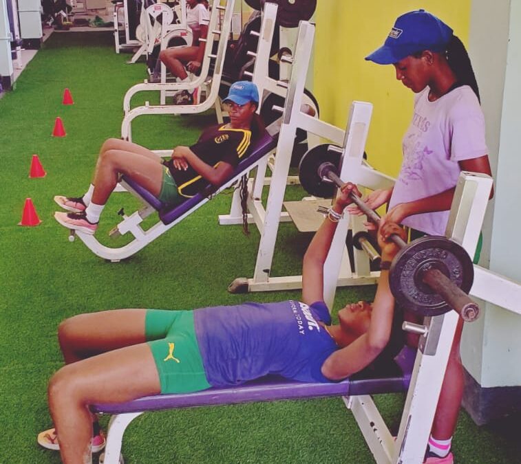 Girls being instructed in weight training in the gym renovated by The Foundation